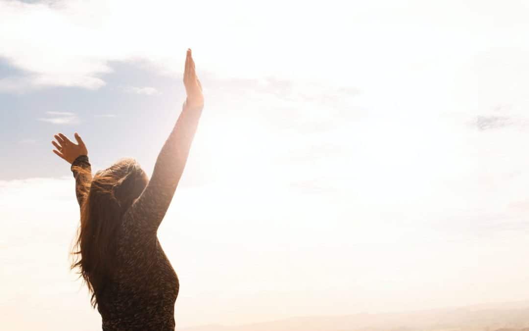 photo of woman raising both hands