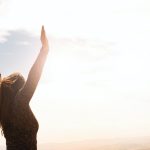 photo of woman raising both hands