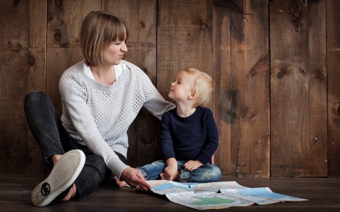 child with woman holding map