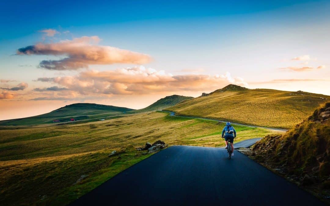 rear view of man on mountain road against sky