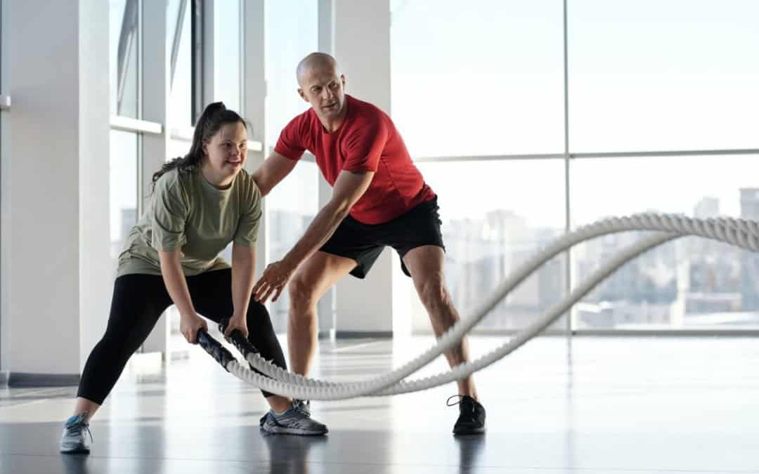 a woman holding ropes beside a trainer