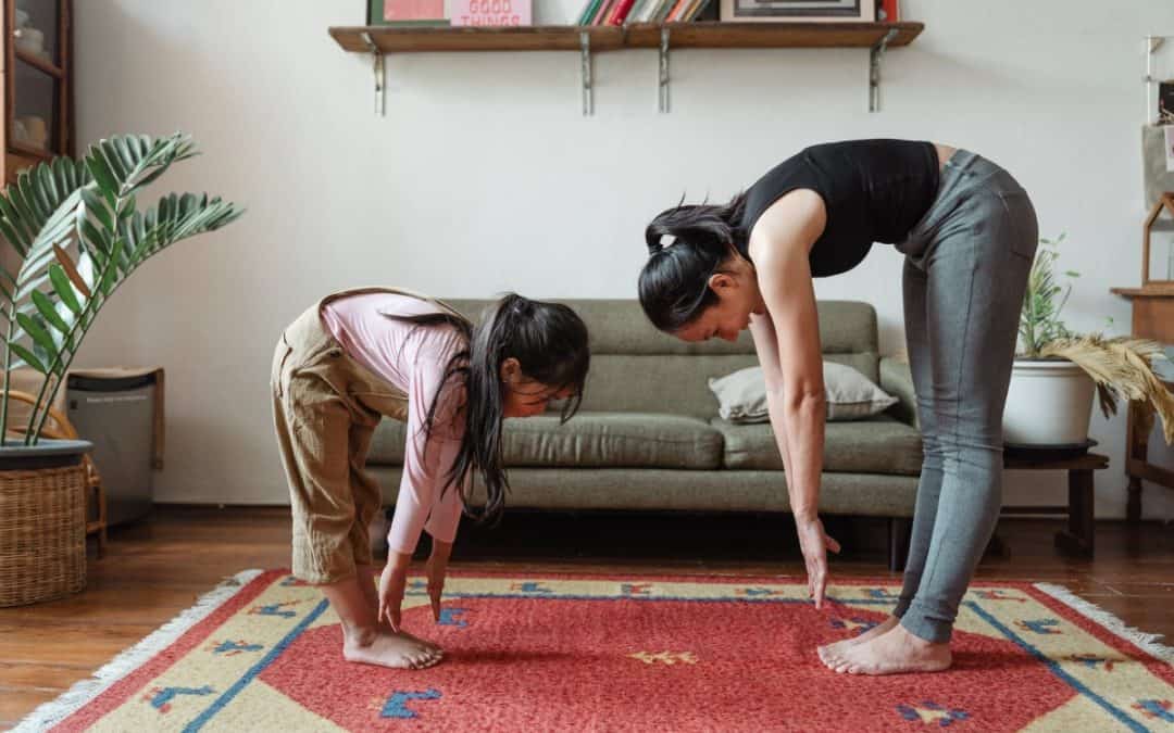 photo of woman and girl stretching their body