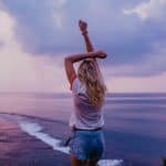 slim woman enjoying endless seascape on beach