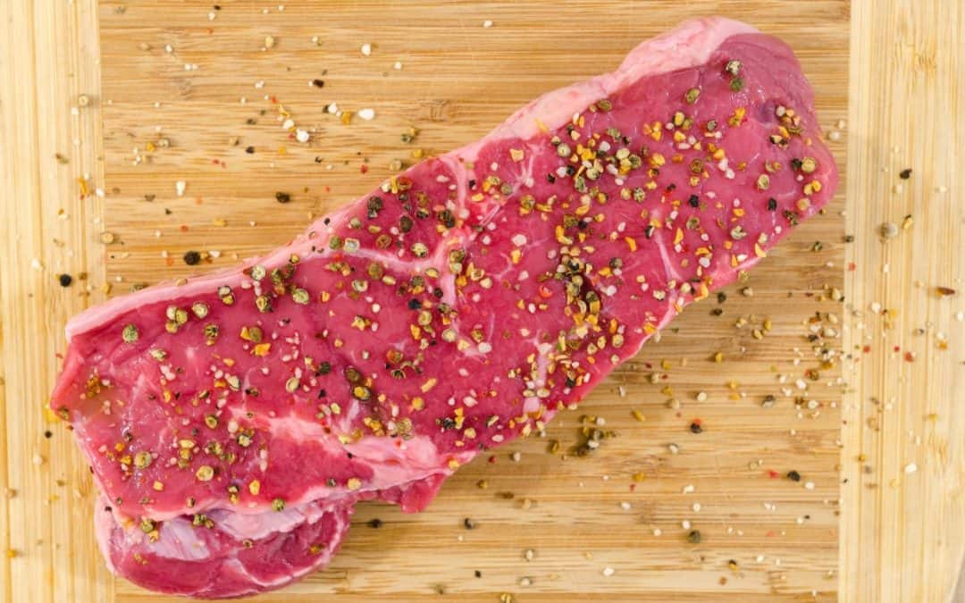 raw meat on beige wooden surface